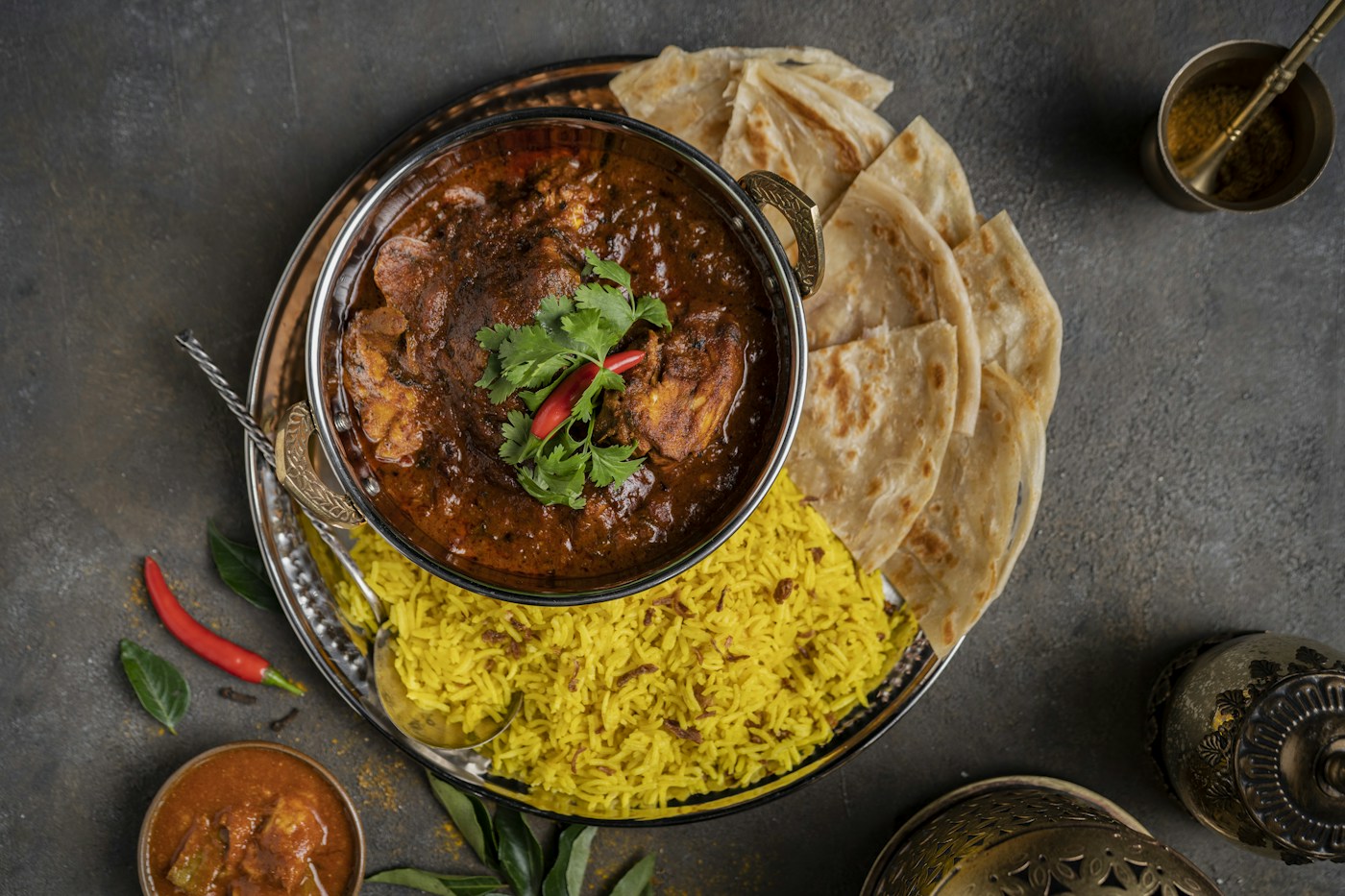 A generous curry, rice and flatbread spread