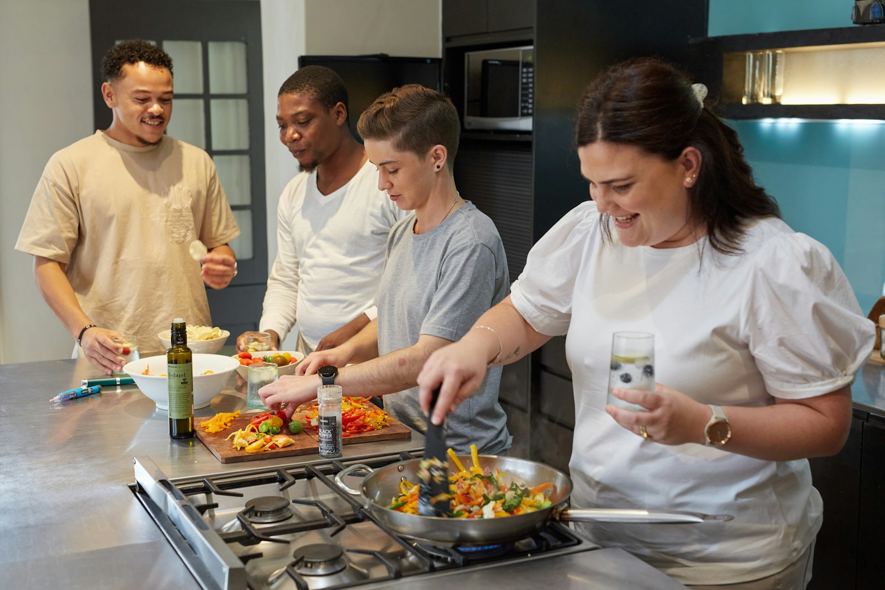 Friends cooking a colourful meal together